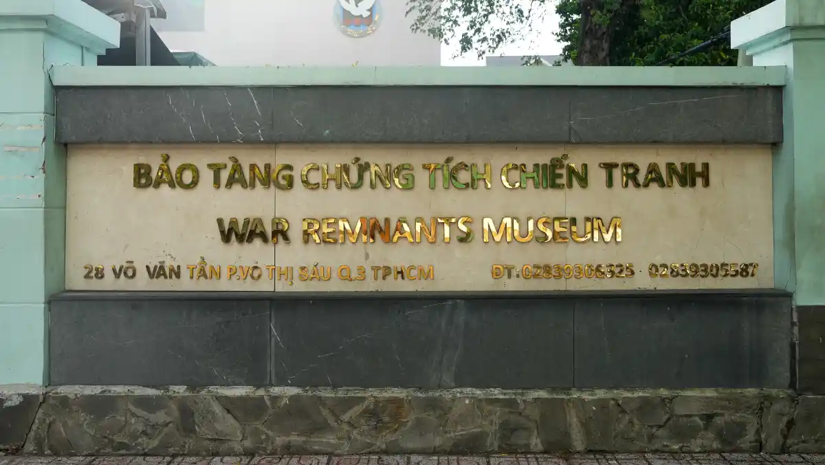 Stone sign of the War Remnants Museum with Vietnamese and English names in gold lettering and the street address 28 Vo Van Tan, District 3, Ho Chi Minh City