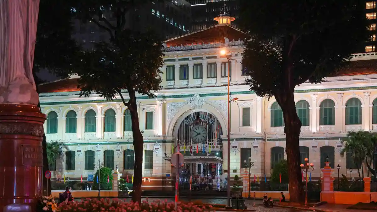 Saigon Central Post Office illuminated in the evening, viewed from Paris Square in District 1, Ho Chi Minh City