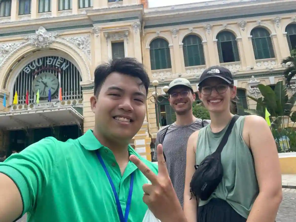 Local guide with international travellers at Saigon Central Post Office in Ho Chi Minh City