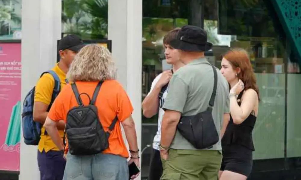 Local guide sharing cultural insights with visitors during a Free Walking Tour Saigon