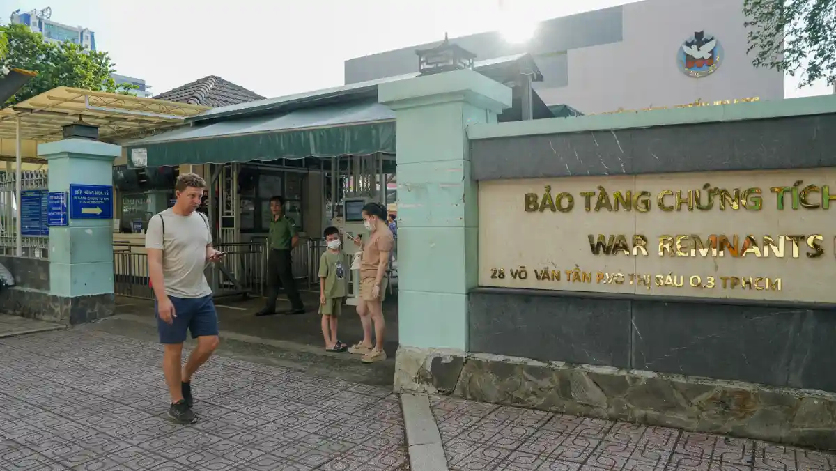 Visitors arriving at the gated main entrance of the War Remnants Museum on Vo Van Tan Street, District 3, Ho Chi Minh City