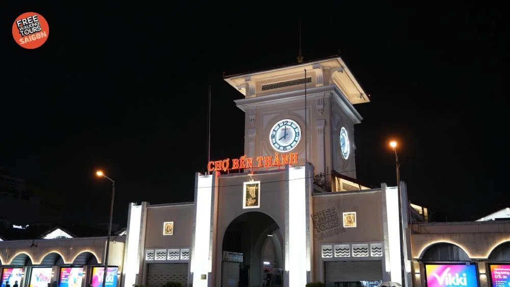 Ben Thanh Market clock tower lit up at night in District 1 Saigon, a finishing point on the Free Walking Tour Saigon route
