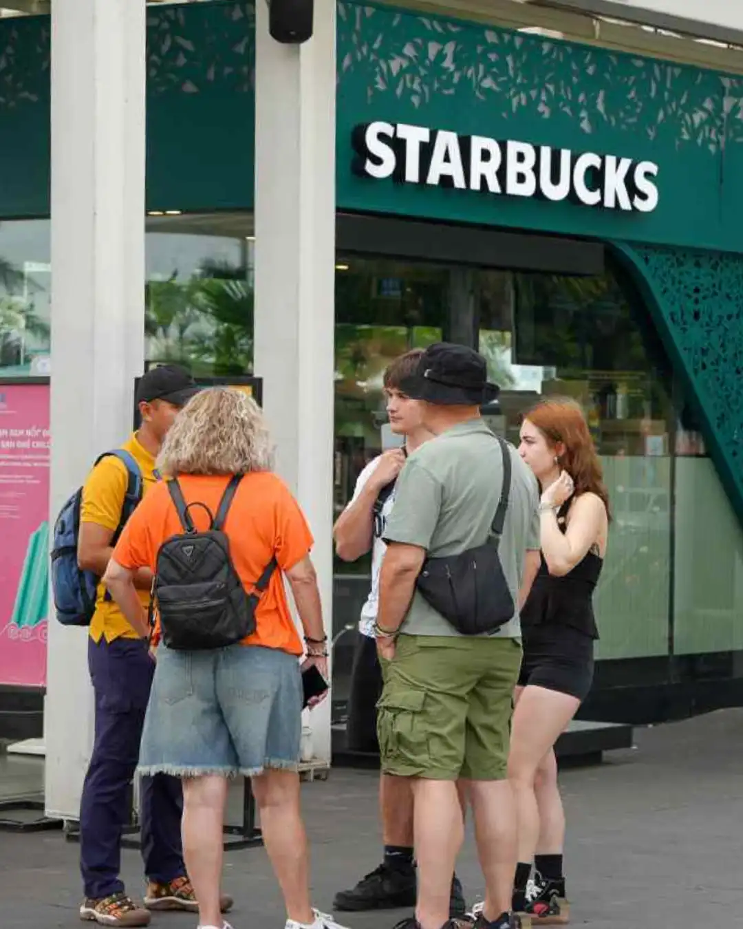 Travellers gathering at the Saigon meeting point with a local guide.