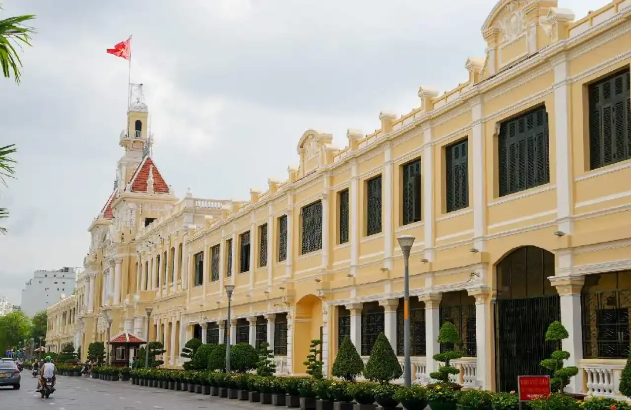 Ho Chi Minh City Hall yellow French colonial facade with bell tower in District 1, the central landmark on the Free Walking Tour Saigon route
